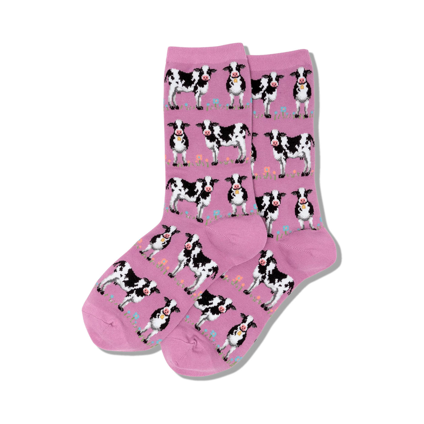 Pair of pink crew socks with a repeating pattern of black and white cows and small flowers. 