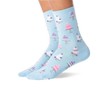 Pair of feet wearing light blue socks with white and pink wedding cake patterns, shown against a white background.