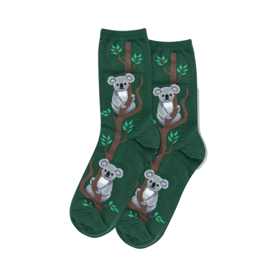 Pair of women's crew socks. Dark green background with a repeating pattern of grey koalas on brown branches with small green leaves.
