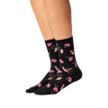 Lifestyle shot of woman's legs wearing black crew socks with hummingbird pattern.