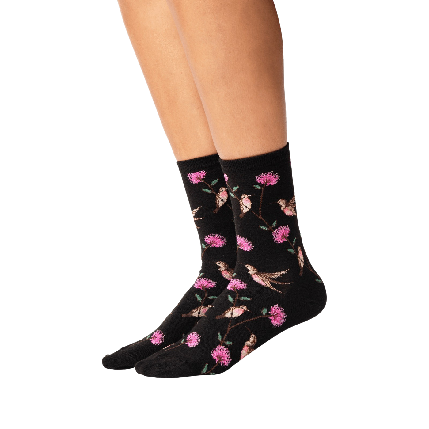 Lifestyle shot of woman's legs wearing black crew socks with hummingbird pattern.