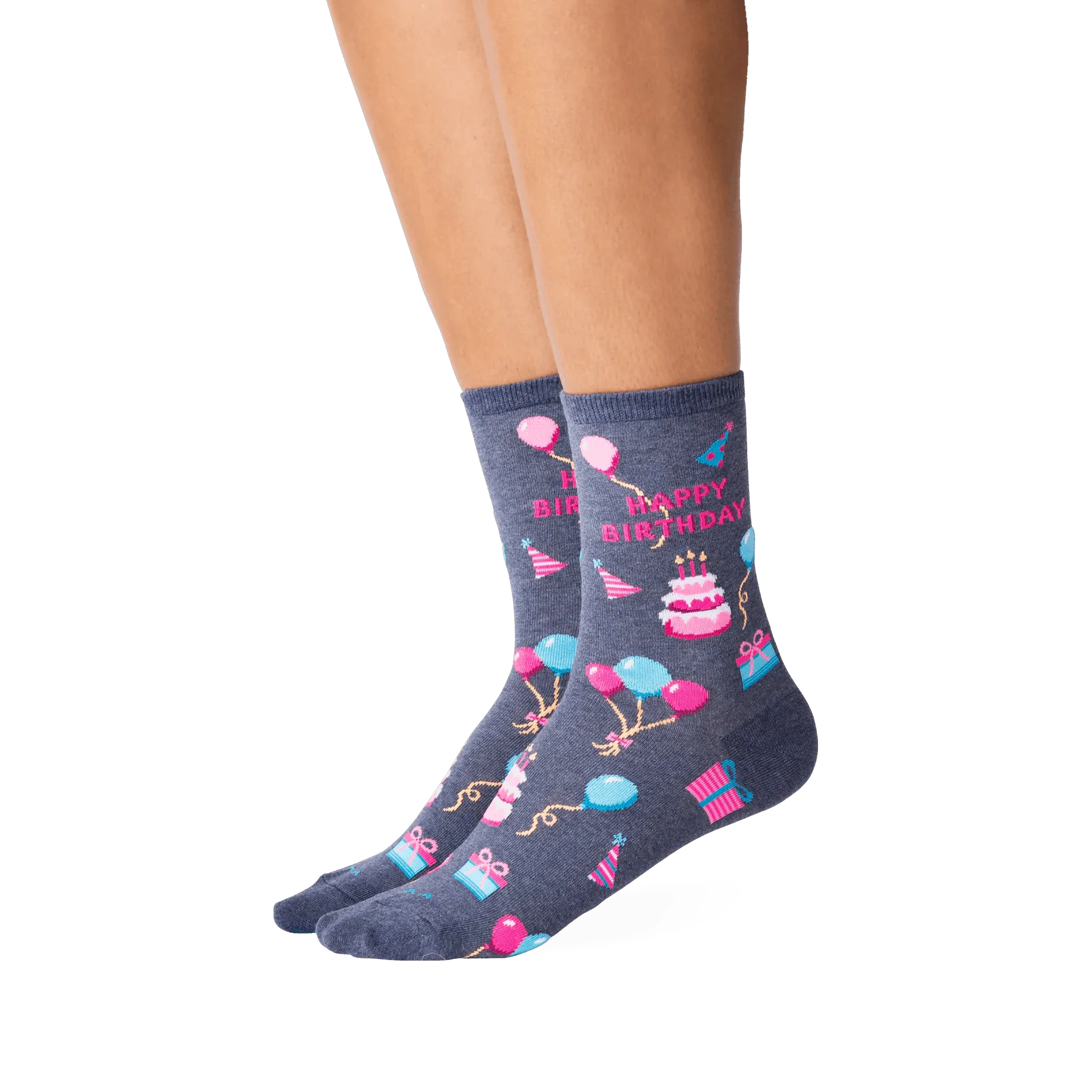 Lifestyle shot showcasing a woman's legs wearing the dark grey 'Happy Birthday' crew socks. The socks' design is clearly visible.