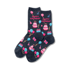 Pair of dark grey crew socks showcasing a 'Happy Birthday' theme. Pink, blue, and white pixelated cakes, balloons, and presents decorate the socks.