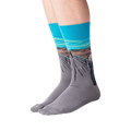 Flat lay of 'The Scream' socks in orange and teal showing full design.