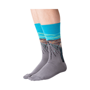 Flat lay of 'The Scream' socks in orange and teal showing full design.