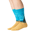 Lifestyle shot: A person's legs wearing the Van Gogh's Wheat Field with Cypress socks.