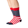 Lifestyle shot showing the American Flag socks on a person's legs. The socks are red, white and navy.
