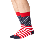 Lifestyle shot showing the American Flag socks on a person's legs. The socks are red, white and navy.