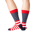 Rear view of the American Flag socks on a person's legs against a green background. The socks are red, white, and navy.