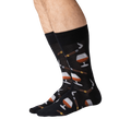 Lifestyle shot of a man's legs wearing the black Cognac and Cigars socks.