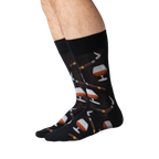 Lifestyle shot of a man's legs wearing the black Cognac and Cigars socks.