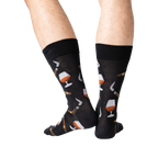 Back view lifestyle shot of a man's legs wearing the navy Cognac and Cigars socks.