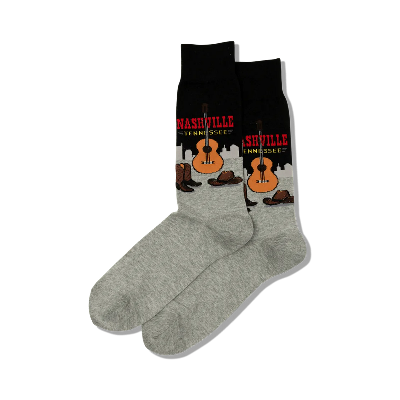 Pair of crew socks; black and grey with a Nashville, Tennessee design featuring a guitar, cowboy boots, and hats.