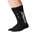Lifestyle shot of a person's legs wearing the Venus de Milo socks. The socks are black with a white image of the Venus de Milo.