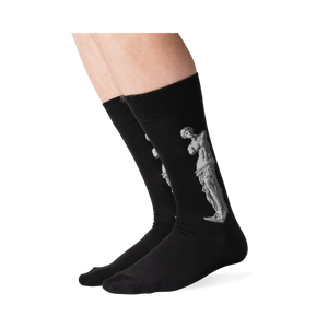 Lifestyle shot of a person's legs wearing the Venus de Milo socks. The socks are black with a white image of the Venus de Milo.