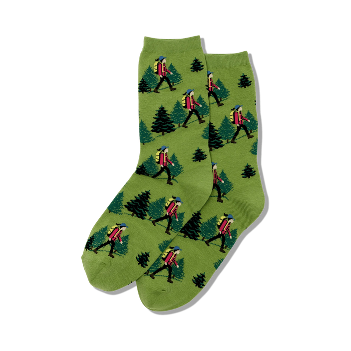 green crew socks with a pattern of a person hiking and pine trees.   