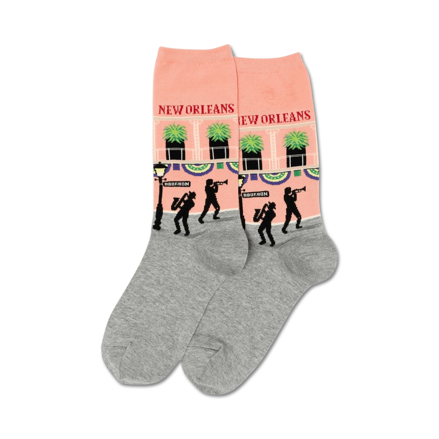 Pair of crew socks. Peach-pink with grey cuffs, they feature a repeating design of a New Orleans street scene with jazz musicians and palm trees.