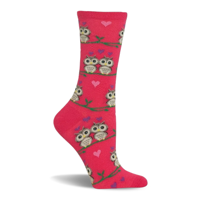 Pink crew sock with a pattern of cartoon owls, some in pairs, sitting on green branches. Small pink and purple hearts are scattered.
