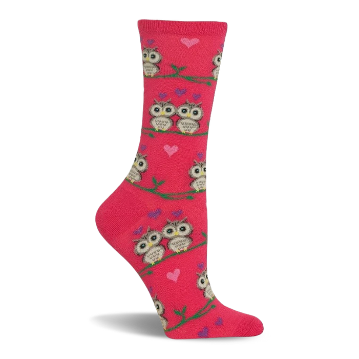 Pink crew sock with a pattern of cartoon owls, some in pairs, sitting on green branches. Small pink and purple hearts are scattered. }}