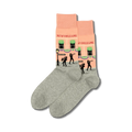 Pair of crew socks in peach and grey.  The peach section features a New Orleans street scene with jazz musicians and buildings.