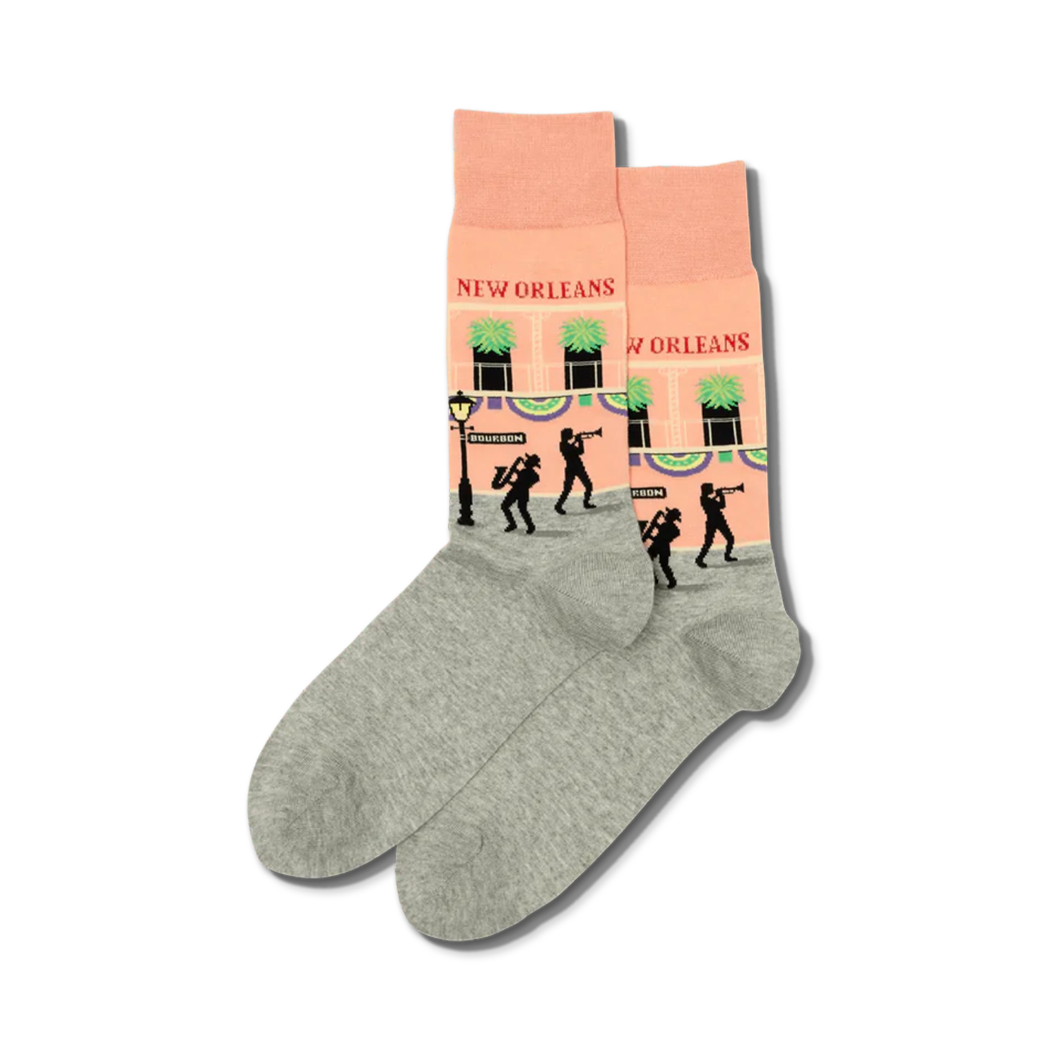 Pair of crew socks in peach and grey.  The peach section features a New Orleans street scene with jazz musicians and buildings.