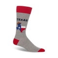Grey crew socks with red cuffs, featuring the Texas flag, cowboy hat, and 'TEXAS' lettering.