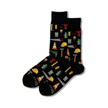 black crew socks with a playful pattern of tools, hard hats, gloves, and caution tape. perfect for handymen and diy enthusiasts.    
