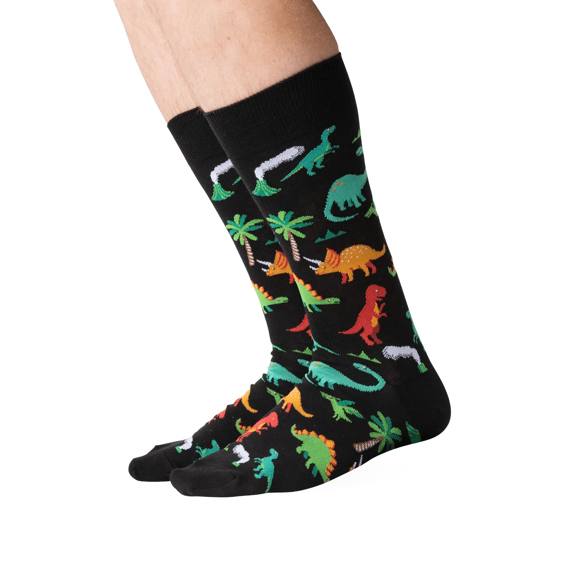 Lifestyle shot showing the dinosaur socks on a person's legs against a green background.