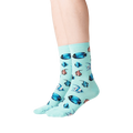 Lifestyle shot showing teal Tropical Fish socks on a person's legs.