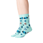 Lifestyle shot showing teal Tropical Fish socks on a person's legs.