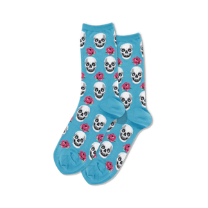 pixelated pink skulls and red roses on a light blue background adorn these women's crew socks, perfect for day of the dead celebrations.  