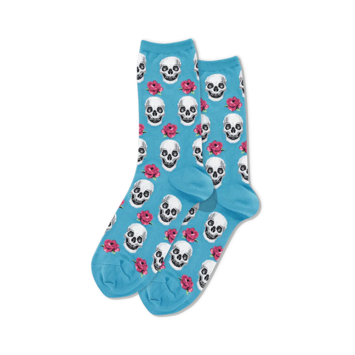 pixelated pink skulls and red roses on a light blue background adorn these women's crew socks, perfect for day of the dead celebrations.  