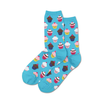 women's blue crew socks with a repeating pattern of pink, blue yellow, and brown cupcakes with frosting, a cherry or sprinkles on top.   