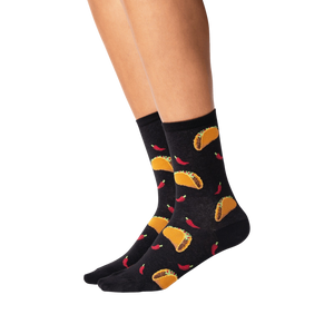 A pair of black socks with a pattern of tacos and chili peppers.