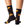 Back view of the same socks on a pair of legs against a black background. The socks' pattern is clearly visible.