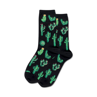 Pair of crew socks on black background.  Black socks feature a fun all-over print of green cacti with pink flowers.