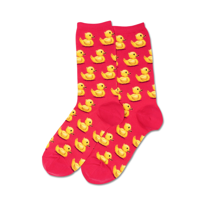 bright pink women's crew socks featuring a cheerful pattern of yellow rubber ducks arranged in neat rows. made of a soft and stretchy material.  