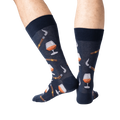 Lifestyle shot of a man's legs wearing the navy Cognac and Cigars socks.