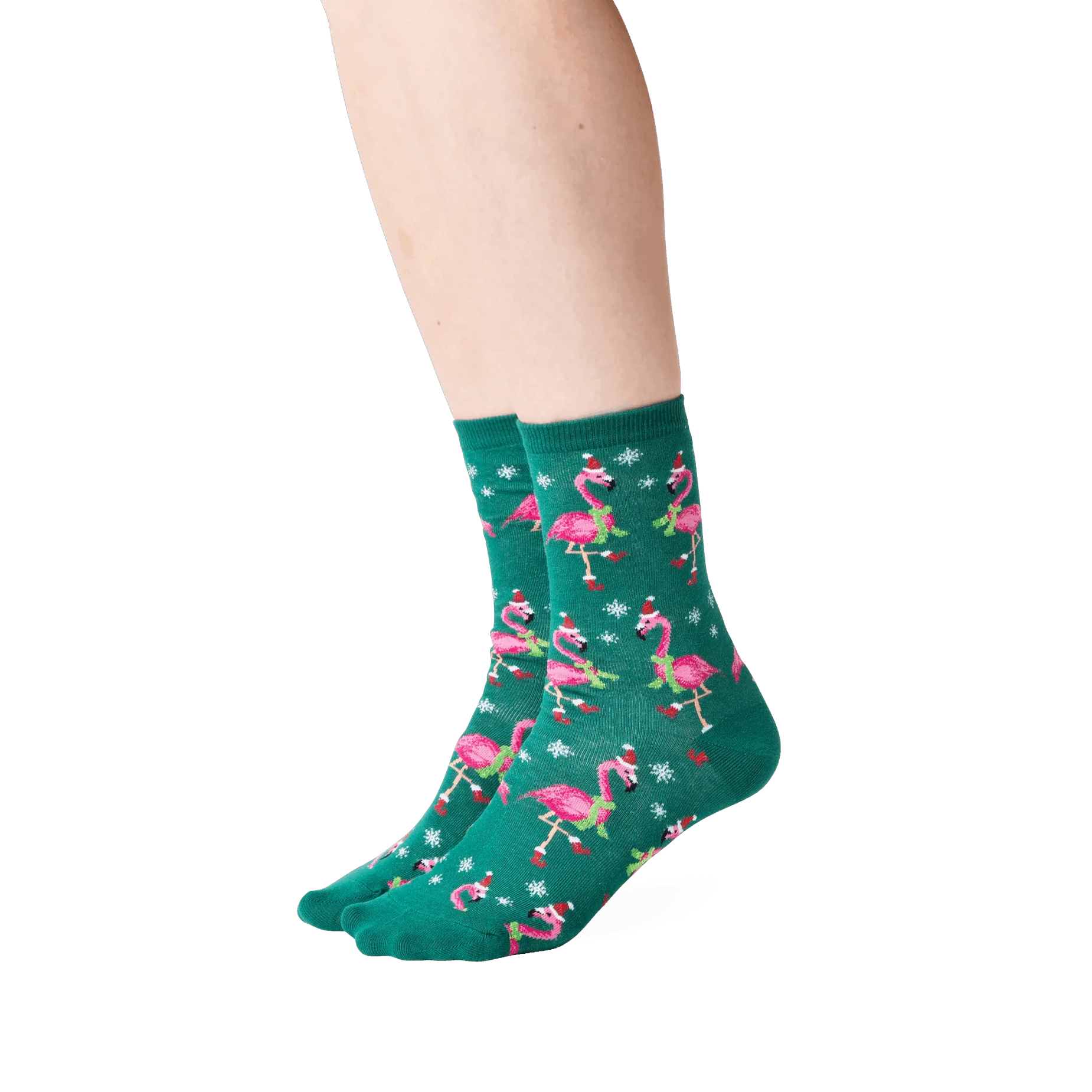 Lifestyle shot: Person wearing dark green crew socks with a pattern of pink flamingos in Santa hats.