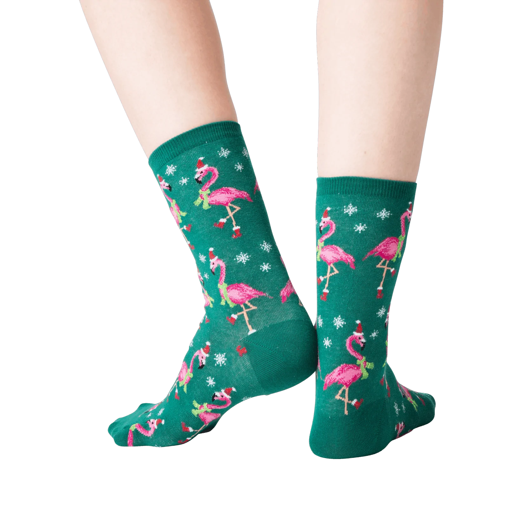 Back view of a person's legs wearing dark green crew socks with a pattern of pink flamingos wearing Santa hats.