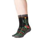 Lifestyle shot showing a person's legs wearing the Christmas Cactus Non-Skid Slipper socks.