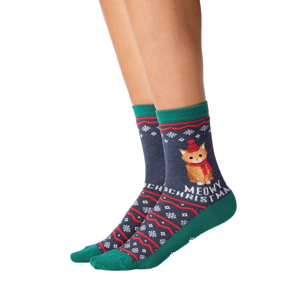 Close-up of model wearing a pair of Meowy Christmas socks.