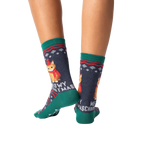 Rear view of model wearing a pair of Meowy Christmas socks.