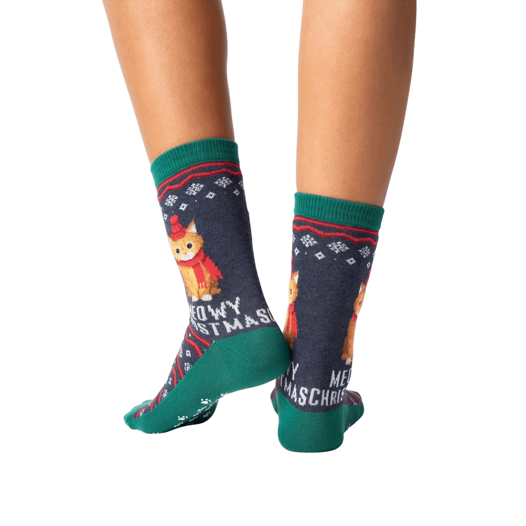 Rear view of model wearing a pair of Meowy Christmas socks.
