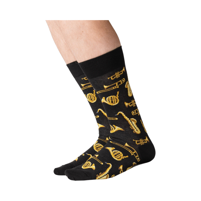 Lifestyle shot of a person's legs wearing black Jazz Instrument socks.