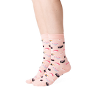 Close-up of a person wearing a pair of light pink sushi socks.