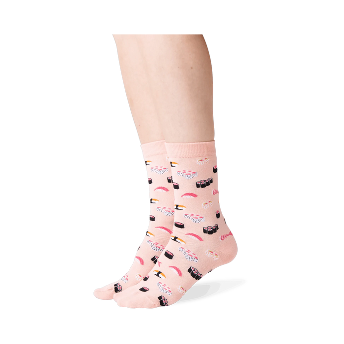Close-up of a person wearing a pair of light pink sushi socks.