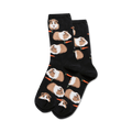 Pair of black crew socks with a repeating pattern of brown and white guinea pigs and orange carrots.