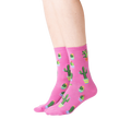 Lifestyle shot showing a model wearing the pink Potted Cactus socks.