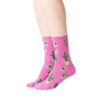 Lifestyle shot showing a model wearing the pink Potted Cactus socks.